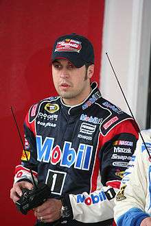 Hornish, in uniform and cap, using a remote car controller