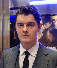 Head-and-shoulders colour photograph of Sam Riley in 2014.