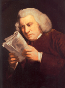 Man staring intently at a book held close to his face