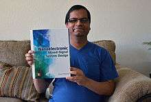 Saraju Mohanty with his best seller nanoelectronic mixed-signal system design book published in 2015 by McGraw-Hill Education.