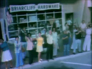 People brandishing firearms outside a hardware store