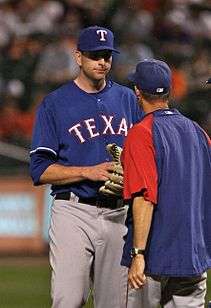 Tall player engaged in a mound conference with shorter man