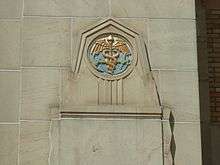 An anchor and caduceus  on the exterior of a building
