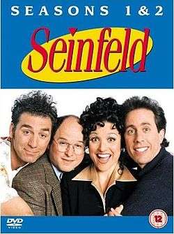 Four people, three men and a woman, hug tightly and smile in front of a white background. At the top, in front of a blue background, are the words "SEASONS 1 & 2" in white, and beneath that phrase is the word "Seinfeld", in red.