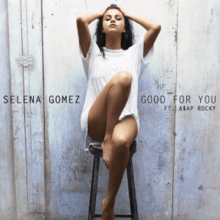 A portrait of a young, brunette woman posing on a stool barefoot wearing an oversized white T-shirt. A white bare wall serves as her backdrop with "Selena Gomez – Good for You ft. ASAP Rocky" centered across the image in black, capital font.