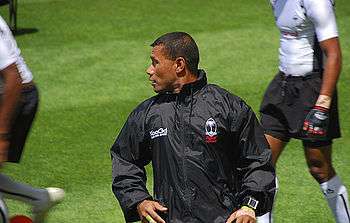 Serevi in a tracksuit stretching