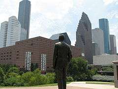 George H.W. Bush statue in Sesquicentennial Park looking towards the Downtown Houston skyline