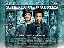 Robert Downey Jr. and Jude Law, in-character. The background is a window display, featuring shelves containing miscellaneous objects relating to the story. The poster reads "Sherlock Holmes" across the top, with the tagline "Holmes for the holiday" centered at the bottom. The poster is predominately turquoise coloured.