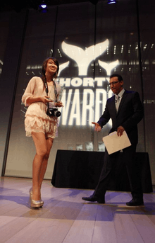 Li receiving her Shorty Award presented by Aasif Mandvi in 2012, NYC (age 16)