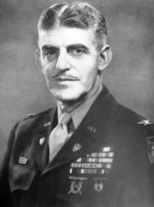 Head-and-shoulders portrait of moustachioed man dressed in army uniform with medal ribbons