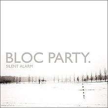 Mostly white album cover with winter image of grey tree line in distance, captioned "BLOC PARTY." and (much smaller) "SILENT ALARM" below it.