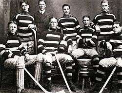 Team in uniform, wearing horizontally striped sweaters