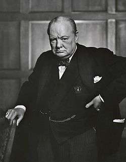 Three-quarter length photograph of Churchill staring into the camera