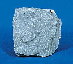 An unpolished, irregular slab of gray slate.