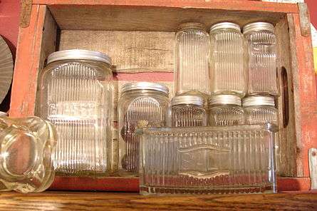 Color picture of old kitchen glassware in a wooden cabinet