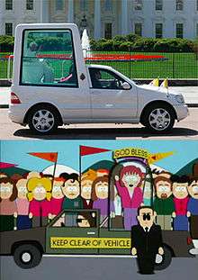 Two images are shown next to each other for comparison purposes. The top images if a modified gray truck with a large dome attached to the back, with a man dressed all in white visible sitting inside. The bottom image is a crudely animated cartoon image of similarly modified brown truck with a woman standing and waving inside the dome. A man wearing a black suit and sunglasses stands in front of the truck, and a large crowd of onlookers stand behind it.