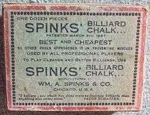 Image: A faded white cardboard box, about 3 by 4 by 1 inches, with a red border and a lot of black text, reading "One dozen pieces SPINKS' BILLIARD CHALK" and various promotional slogans such as "BEST and CHEAPEST", and "USED BY ALL PROFESSIONAL PLAYERS", among other lines, some indistinct.