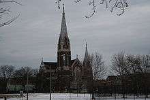 the front of St. Michael's Church from across a snowy baseball field