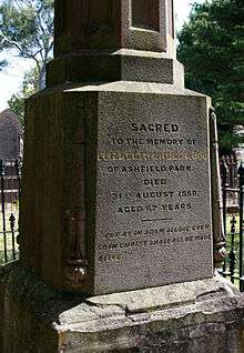 Close up photograph of a sandstone gravestone with oblique lighting to highlight the inscription