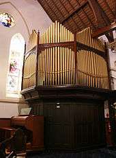 A photograph of the pipe organ, including the console
