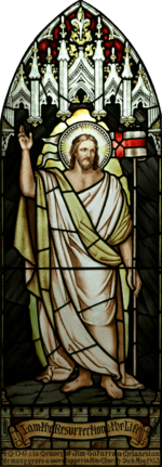 High resolution, perspective corrected stained-glass image of Jesus with a halo, dressed in white and gold robes, with his hand raised, and the banner "I am the Resurrection and the Life", together with a dedication to a deceased parishioner