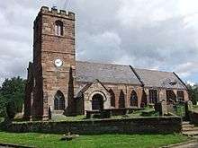 A stone Gothic church with a battlemented tower