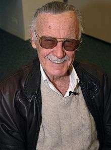 Superhero legend, Stan Lee smiling for the camera with his iconic shades.