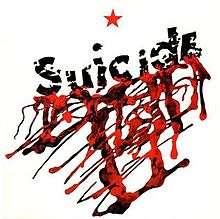A white square shape featuring the a red star at the top center. Below the word Suicide is written diagonally across with blood seeping from it.