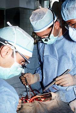 A thoracic surgeon performs a mitral valve replacement at the Fitzsimons Army Medical Center.