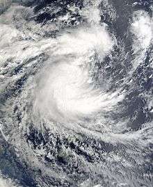 Satellite image of a strengthing tropical cyclone. It developed a ragged central dense overcast, with some area of thunderstorms and clouds.