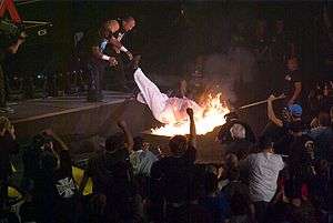 Team 3D forcing Abyss through a flaming table at Bound for Glory IV