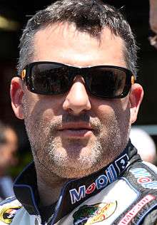 Image of man in his forties, wearing sunglasses and with a shaved beard.