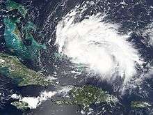Satellite image of a rather weak tropical cyclone - the storm is an elongated mass of clouds, stretching horizontally.