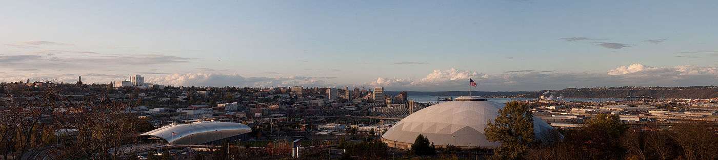 Panorama of Tacoma from the McKinley neighborhood with the Tacoma Dome in the foreground and the Puget Sound in the background.