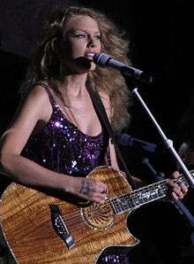 A photograph of Taylor Swift performing at the Cavendish Beach Music Festival in Prince Edward Island, Canada