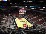 A basketball arena with a Louisville Cardinals logo at center court
