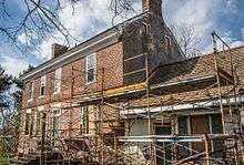 Old brick house with scaffolding in front