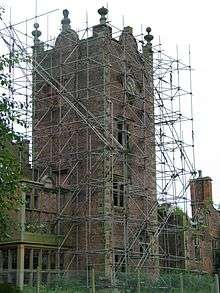 A view of the clock tower covered in scaffolding