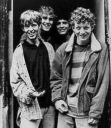 Black and white image of The La's standing in a doorway
