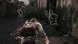 The player character is crouching, with his companion nearby. Enemies lurk in the distance, with a white outline alerting players of their location.