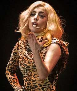 A picture of a woman wearing a leopard print outfit and long blond hair