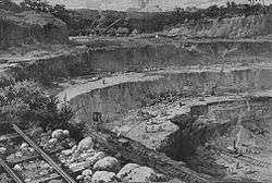 Illustration of a large, terraced excavation