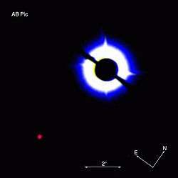 Coronagraphic image of AB Pictoris showing a companion which is either a brown dwarf or a massive planet
