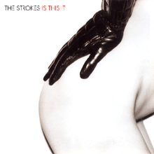 Mostly white album cover containing, largely in the right-hand side, a woman's nude right bottom and hip, with a black leather-gloved hand resting on it. It is captioned "THE STROKES IS THIS IT" in the top left-hand corner.
