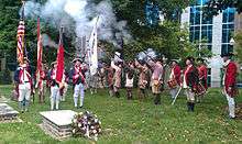 Re-enactors fire a gun salute at the grave of Thomas Polk.