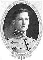Man facing right in gray cadet uniform with black trim
