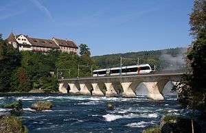 THURBO-operated Stadler GTW unit crossing the bridge near Rheinfall on an S33 service, Laufen castle in the background.