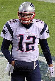 Tom Brady in Patriots uniform, walking towards camera in 2015.