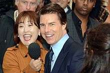 Tom Cruise being interviewed at a film premiere.