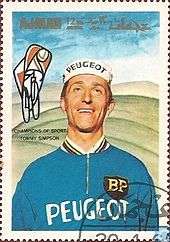 Tom Simpson wearing a white cap and blue jumper, with Peugeot insignia